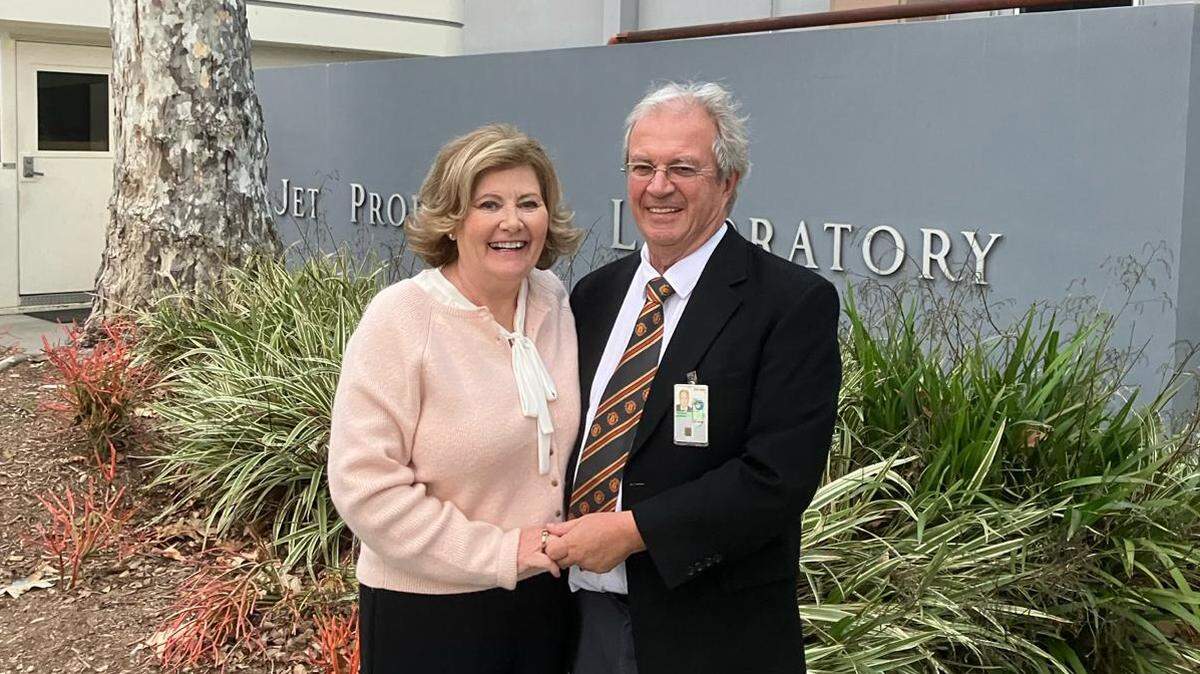 British expat Tony Freeman, with his wife Phyllis Freeman, stands in front of NASA’s Jet Propulsion Laboratory, where he worked for more than four decades, earning Great Britain’s second highest honor for a civilian. They retired to their Cambria home in April 2024.