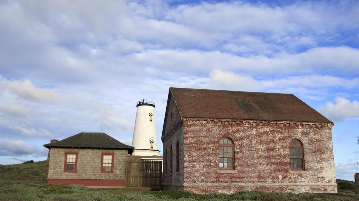The fog signal building, the blacksmith shop building and the lighthouse at Piedras Blancas.
