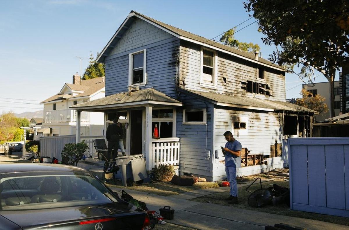 A van crashed into the Railroad Square building on Santa Barbara Street early Tuesday morning, taking out a power pole, bottom right, which triggered a fire in a nearby house on Morro Street.