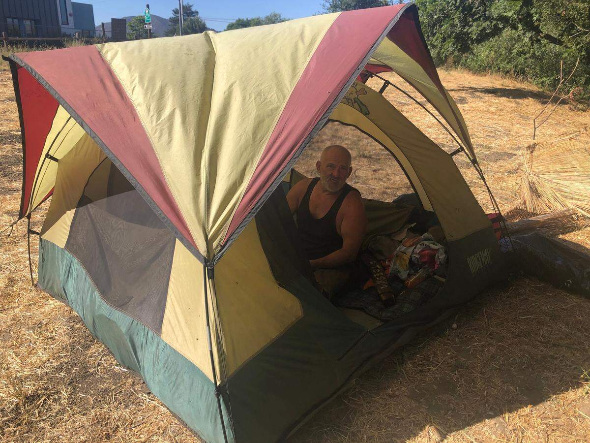 Sam Clanin rests in his tent along the creek near Prado Road.