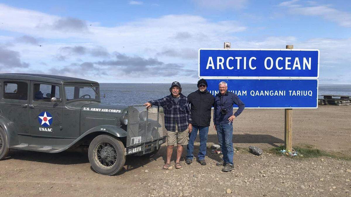 Jay Burbank, left, Tim Murdoch and Charlie Enxuto celebrate their July 2, 2023, arrival at the tiny burg of Tuktoyatuk on the Arctic Ocean, in the northern Canadian territories, after a 7,000-mile, nearly monthlong drive from Cambria. Burbank organized the trip to honor veterans in the U.S. and Canada.