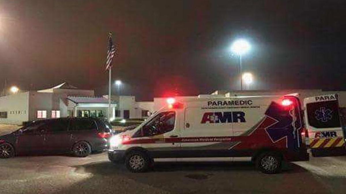 An AMR ambulance waits outside the Lompoc Federal Correctional Complex on Wednesday night after a report of a large fight. Nine inmates and three staff members were hurt in the incident.