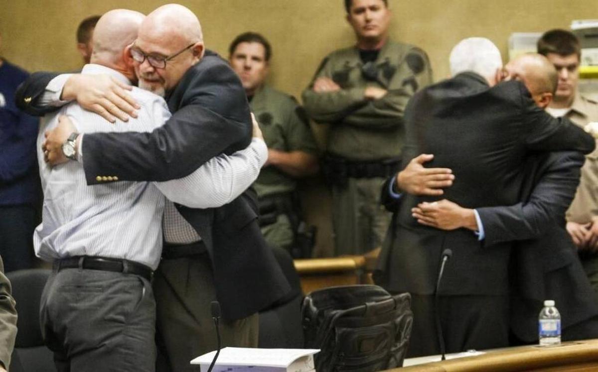 Former Salinas Valley State Prison guard Travis Woolf, left, hugs defense attorney Ilan Funke-Bilu while co-defendant Sergio Aranda, right, hugs his attorney in May 2016 after the two were acquitted of manslaughter in the death of Alvaro Medrano following a fight outside the Elkhorn Bar in San Miguel on Sept. 7, 2014.