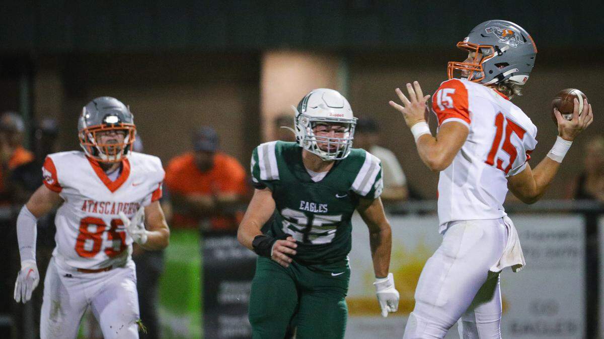 Kane cooks passes under pressure from Kohen Sizemore, Cole Loney is at left. Templeton lead for most of the game but at the end Atascadero came up with the win 20-16 Oct. 6, 2023.