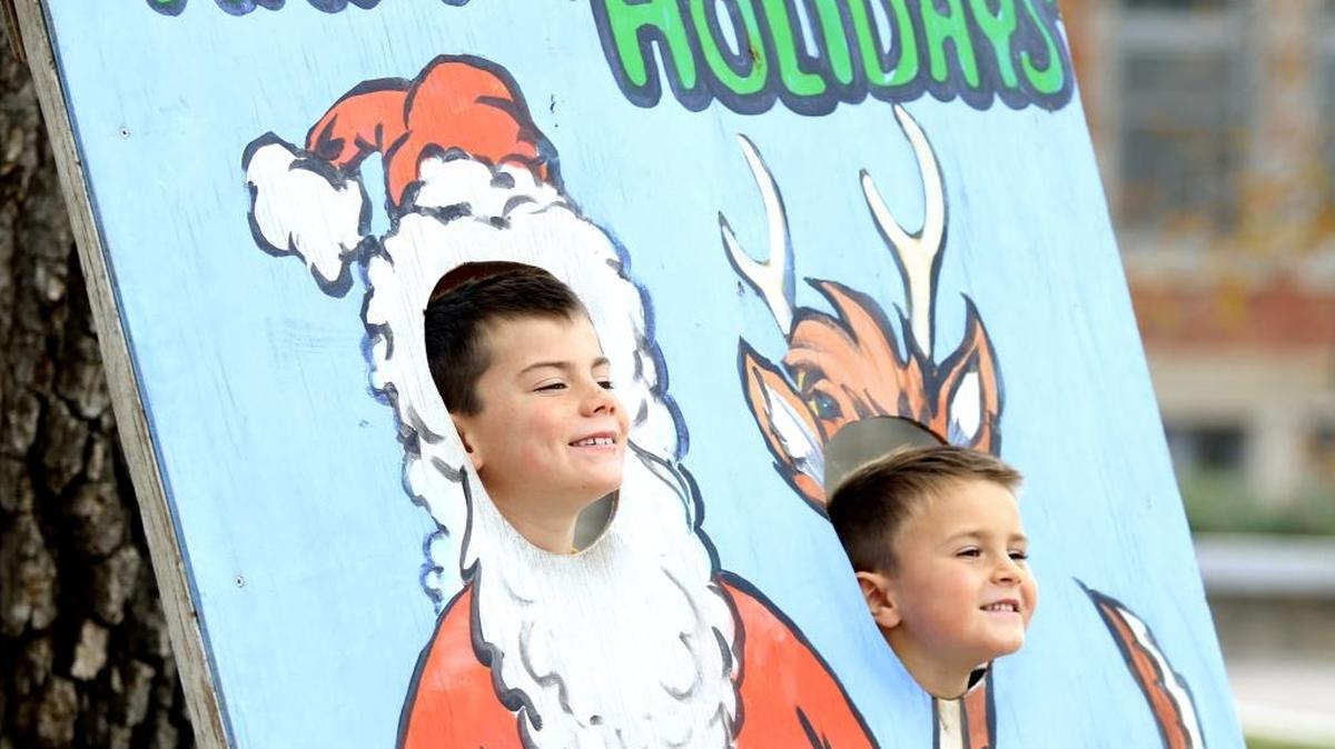 Brothers Lukas Combrink, 7, and his brother Jakob, 5, of Paso Robles, get their photo while waiting to visit Santa on Sunday afternoon in Paso Robles.