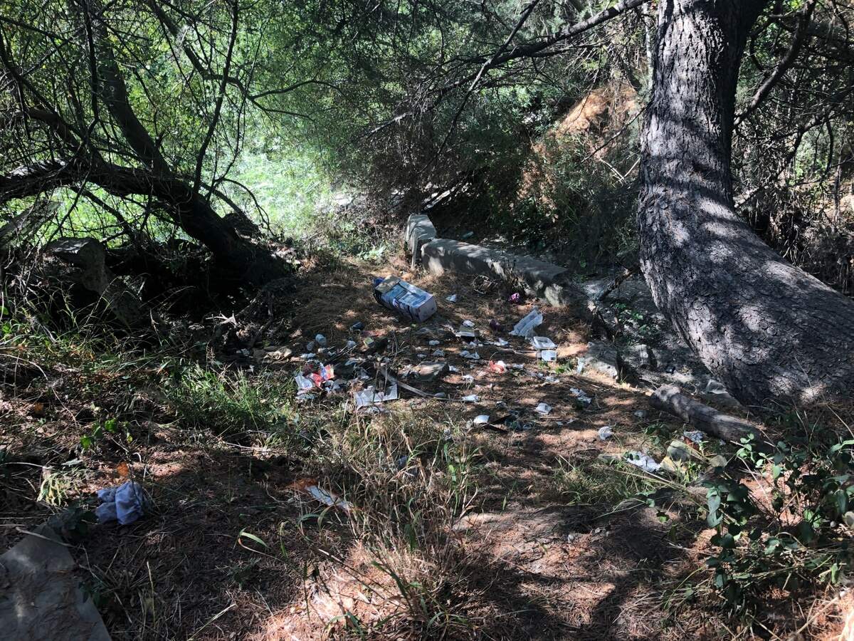 Trash is scattered near San Luis Obispo Creek by the Elks Lodge. An increased number of homeless campers have gathered in the area, according to lodge officials.