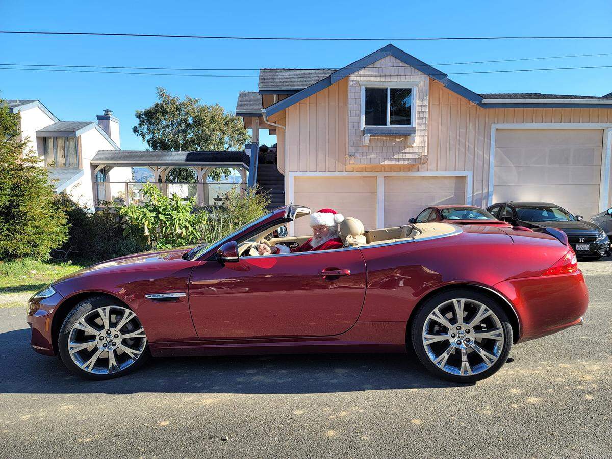 Santa (Tom Tierney of Cambria) takes his alternate ride (a 2020 Jaguar) for a spin before getting aboard his more traditional transportation.