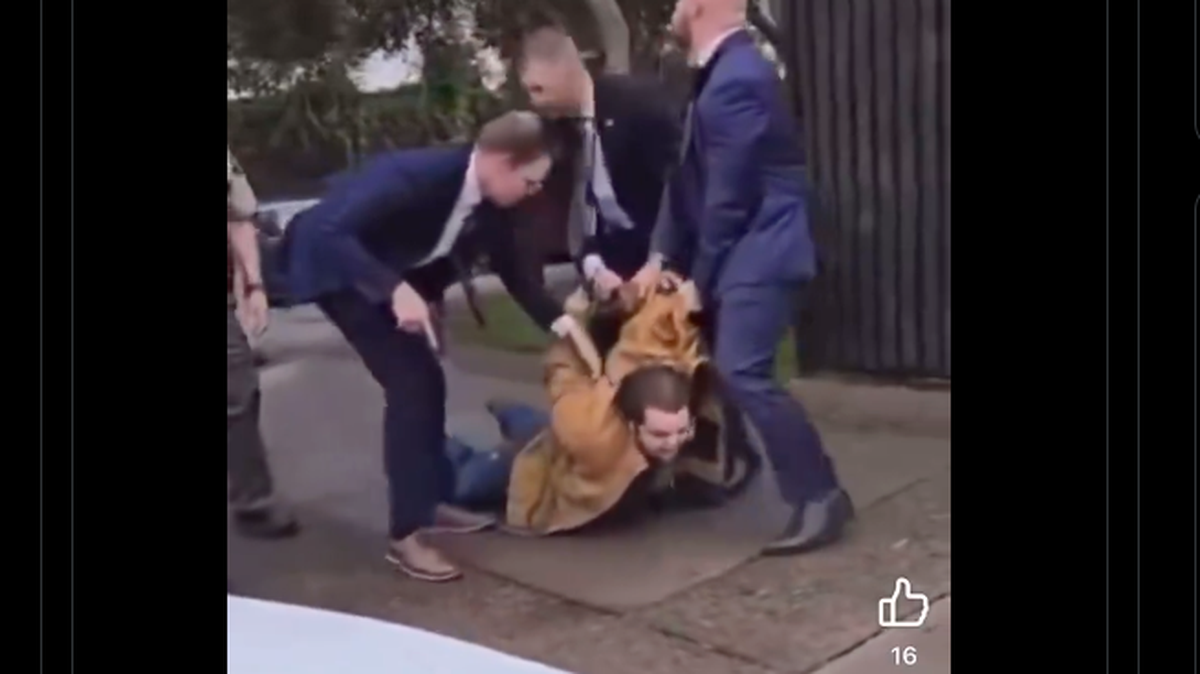 A screenshot of a video posted on X shows three men dragging the suspect in a bombing at the Santa Maria Superior Courthouse outside the building on Wednesday, Sept. 25, 2024.