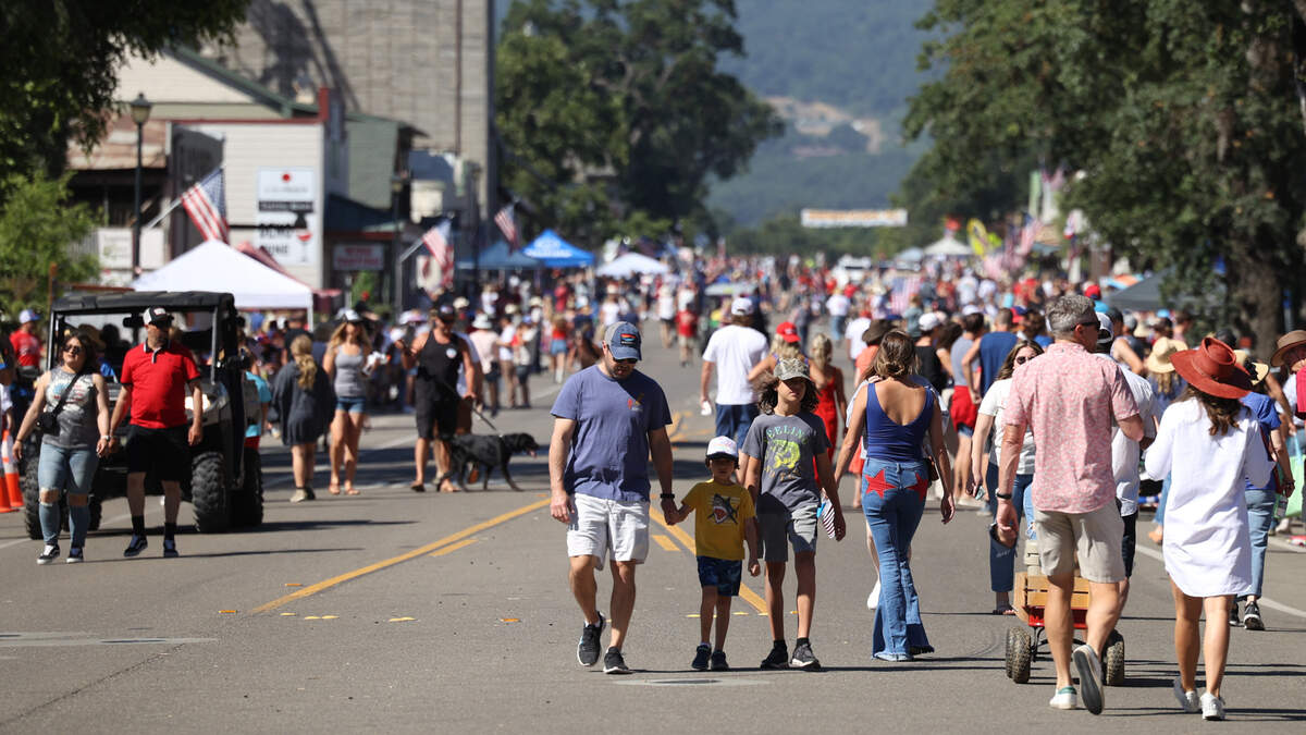 People walk down the street in Templeton on Tuesday, July 4, 2023.