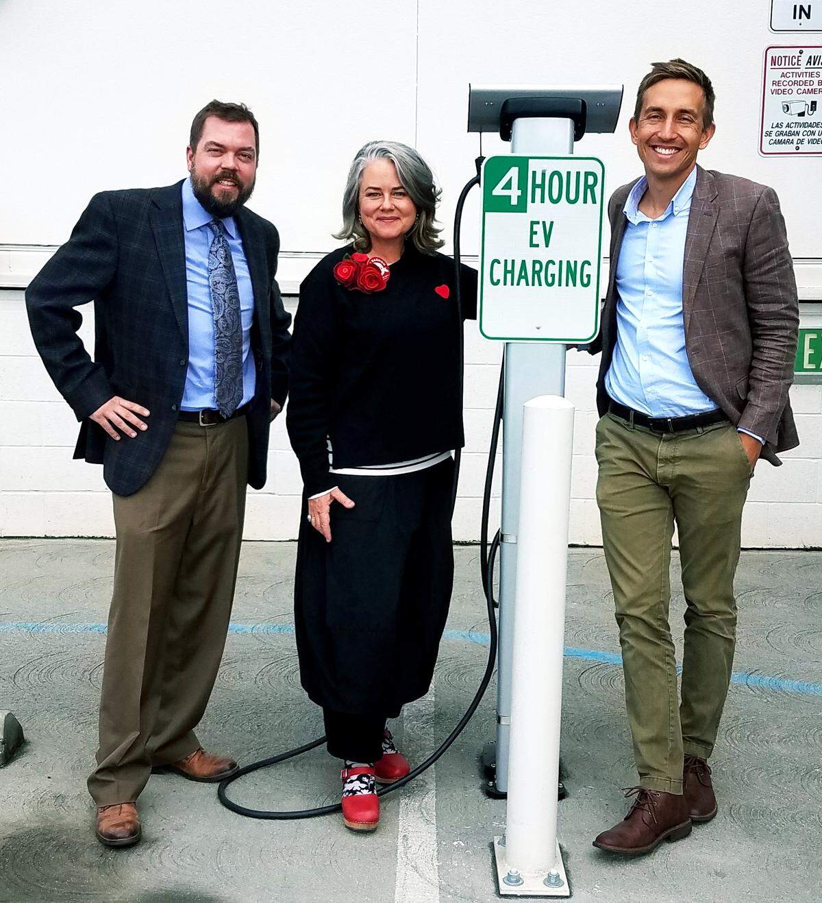 SLO’s Natural Resources Manager Bob Hill, Mayor Heidi Harmon, and Sustainability Manager Chris Read (from left to right), pose near an electric vehicle charging station. The city has a 2035 carbon neutral goal.