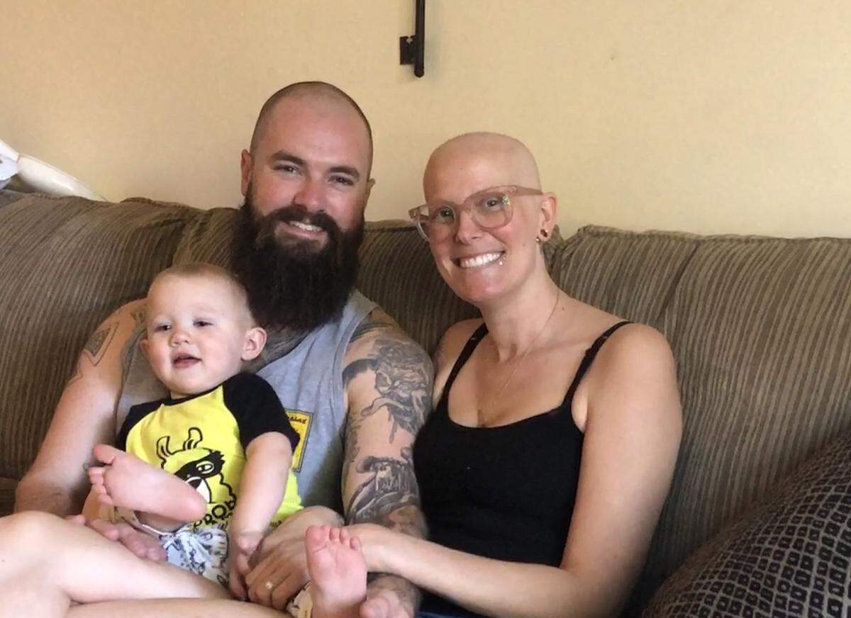 Travis and Brittany Hunt relax at home with their young son, Paxton.