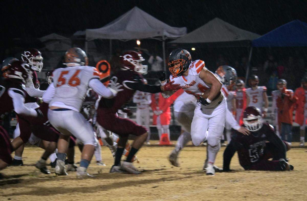 Atascadero’s Trey Cooks looks to avoid a tackler as Atascadero beat Colusa 21-0 on Dec. 2, 2022, in the CIF Division 6-A Regional Final to advance to the state championship game.