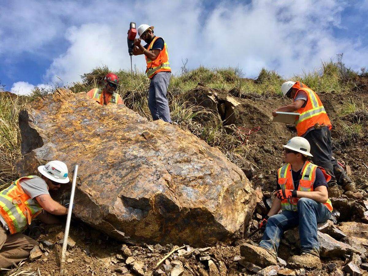 Crews prepare to blast a boulder along Highway 1 near Paul’s Slide. Storms and slide activity caused Caltrans to close the road.