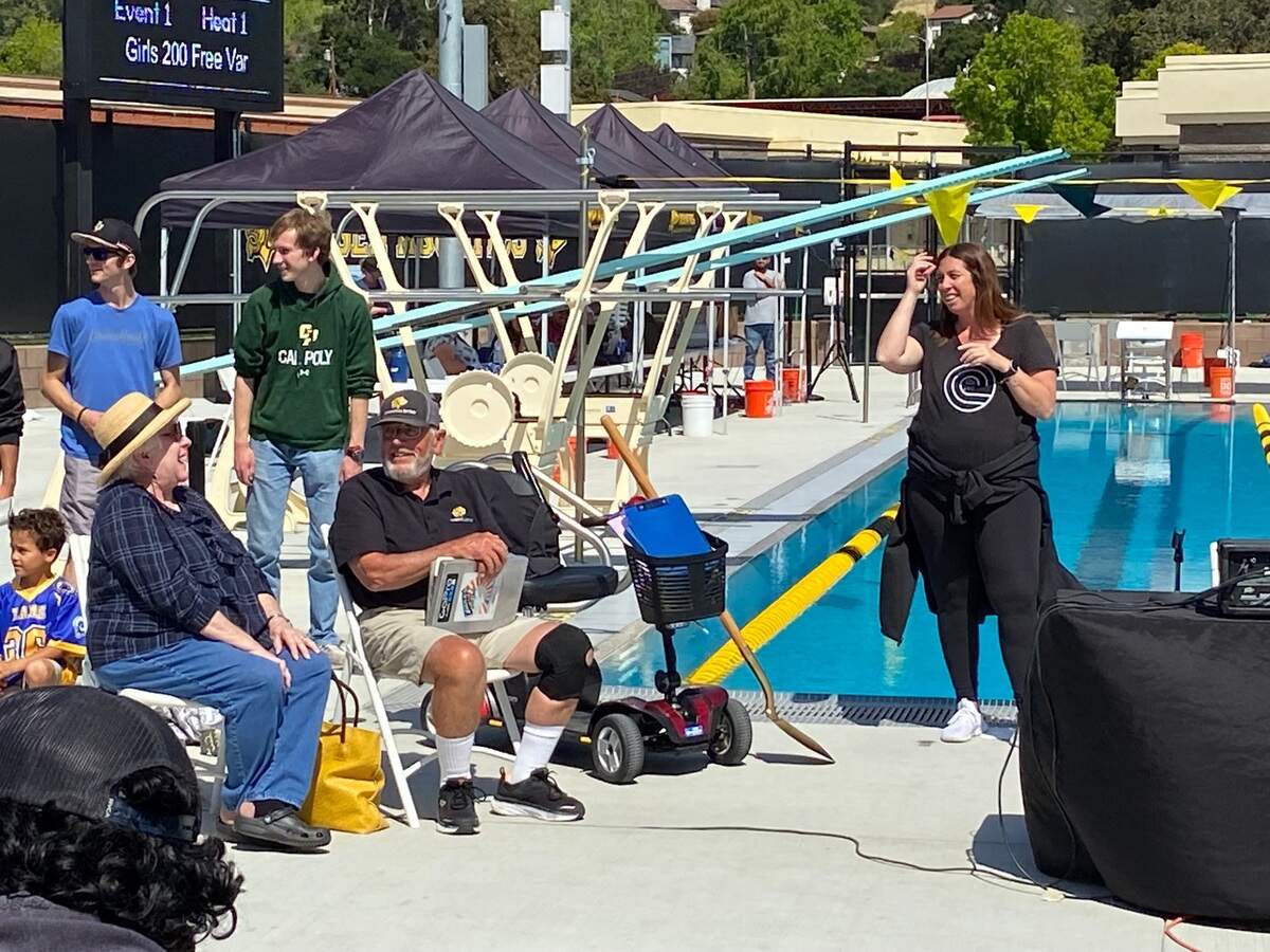 Marci Beddall (right), SLO High’s Athletic Director, celebrate the retirement of 53-year swim coach Rick Ernstrom.
