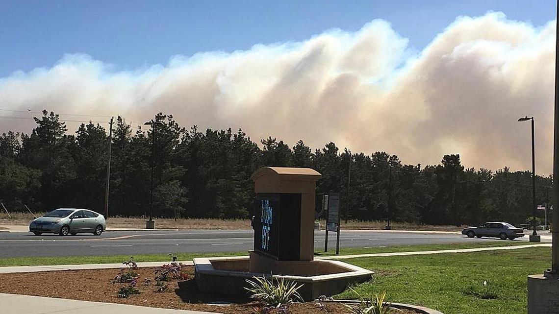 Smoke from the North Base vegetation fire can be seen from the main gate visitor center parking lot on Vandenberg Air Force Base on Thursday afternoon.