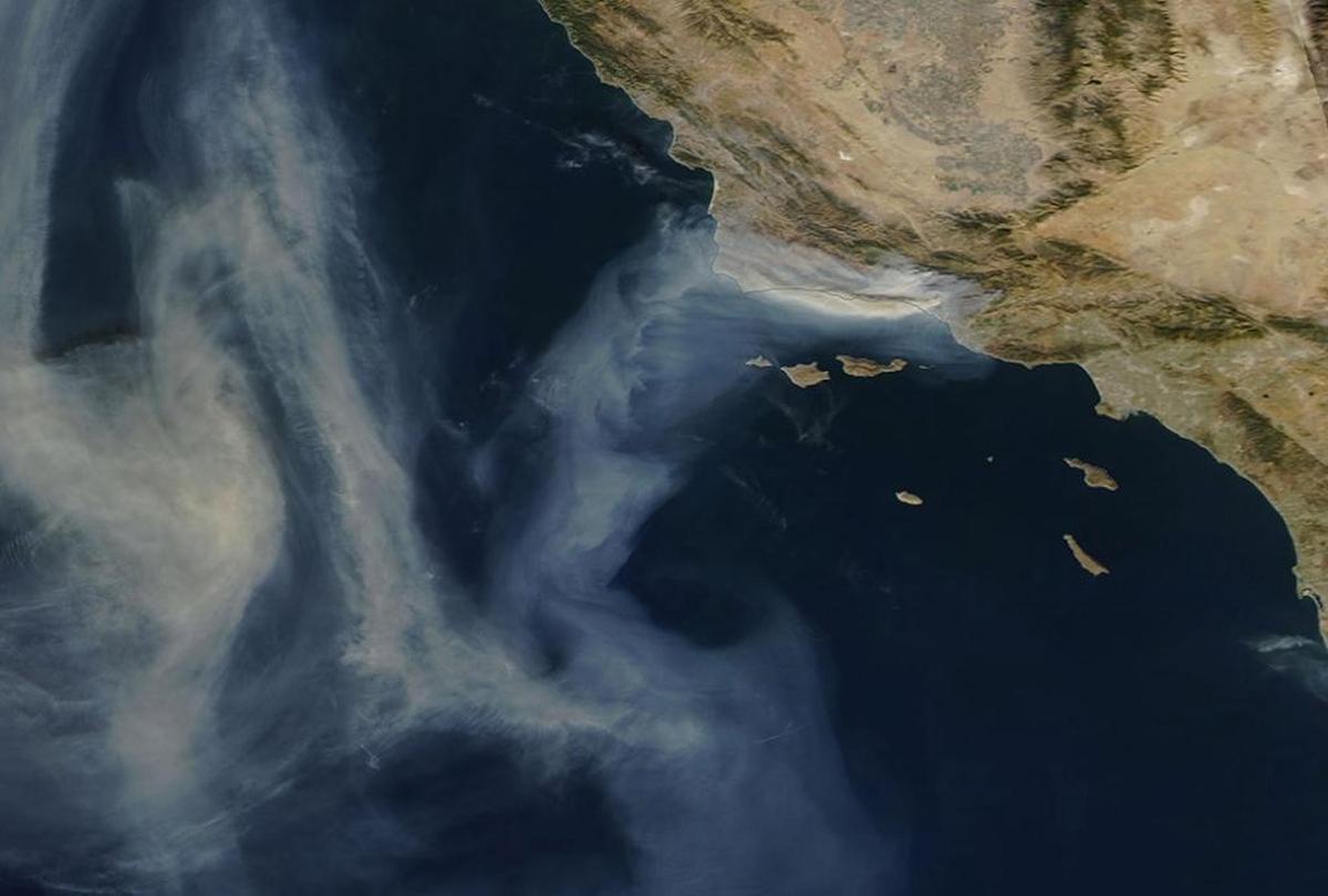 An image from the Aqua satellite, which launched from Vandenberg Air Force base, shows Thomas Fire smoke on Tuesday, December 12, 2017 stretching from Santa Barbara all the way to Oregon and Washington.