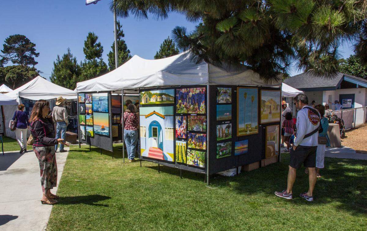 Visitors peruse arts and crafts at Morro Bay Art in the Park. The event returns July 2-4.