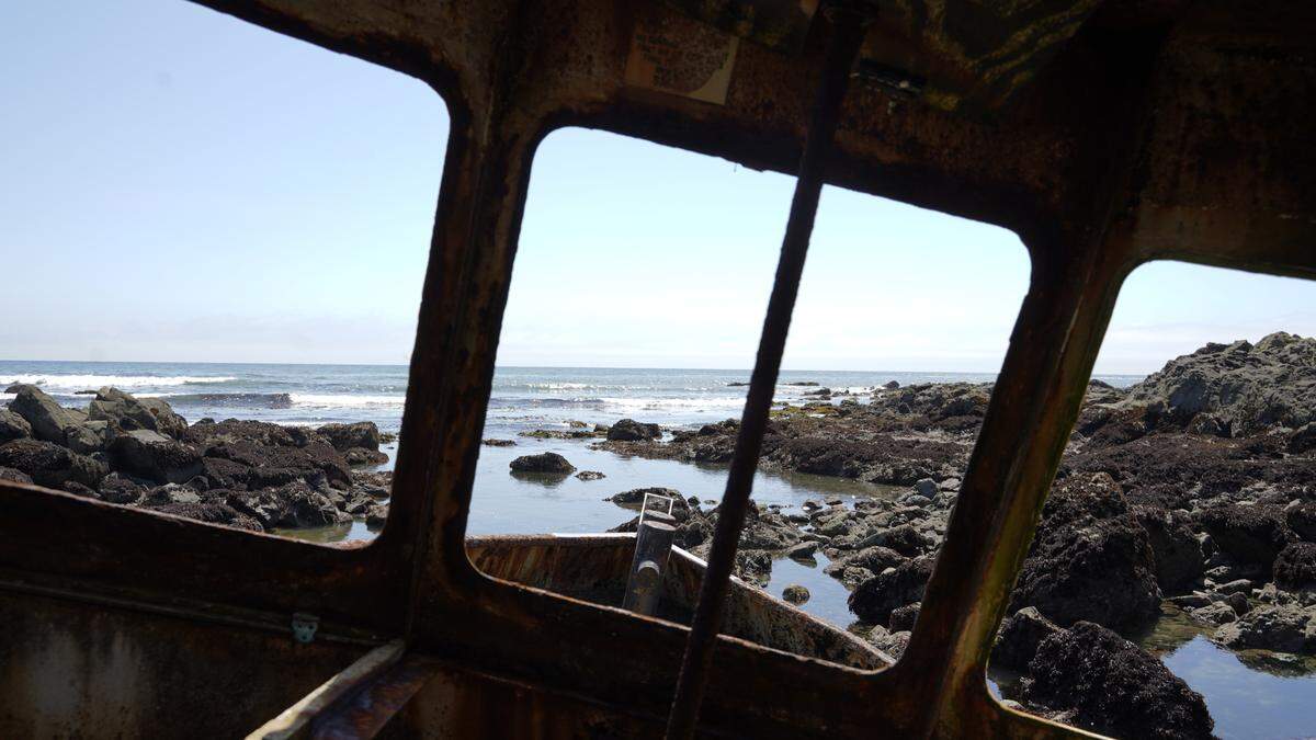 Fisherman Jonathan Smith ran aground in Estero Bay in 2017. His boat remains on the shore, and visitors climbed aboard to see a view of the ocean through what once was the windows.