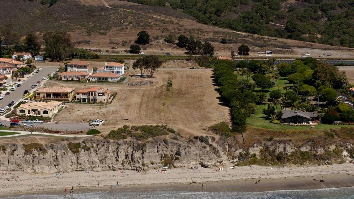 An aerial photo shows the site of the proposed Shell Beach townhome project
