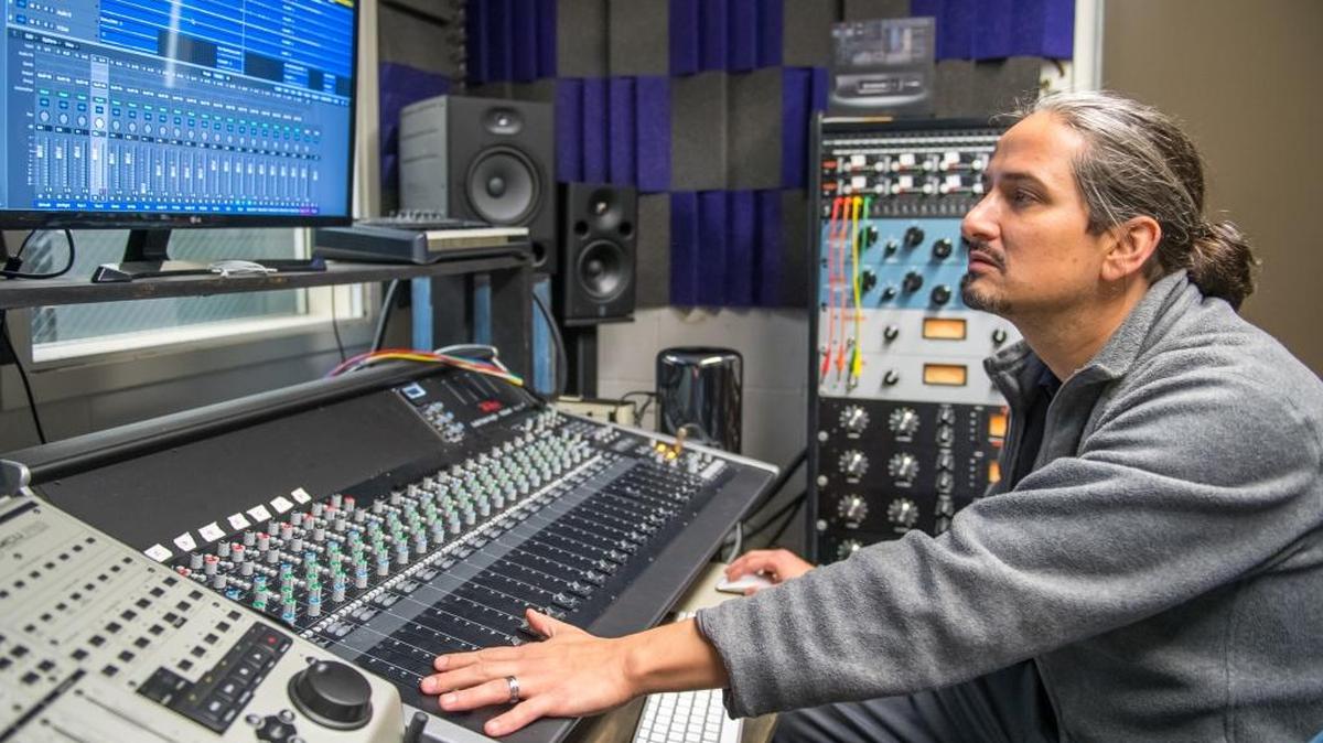 Professor Christopher Diaz demonstrates the Logic XL mixing console used in Allan Hancock College’s Sound Production Techniques class.