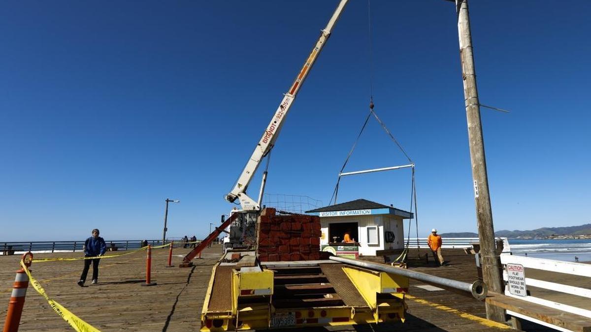 Workers prepare to move the Visitor Information booth at the Pismo Beach Pier on Monday, March 6, 2017, as the renovation project to update and repair parts of the aging structure gets underway.