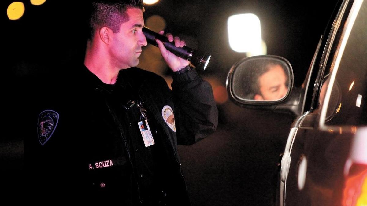 Officer Adrian Souza of the Pismo Beach Police Department speaks with a driver of a vehicle during a traffic stop that was initated by Sgt. Sean Singleton on Pier Avenue in Oceano in 2012.