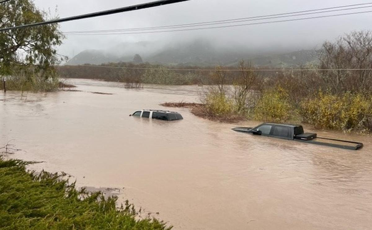 Floodwaters cover vehicles on South Bay Boulevard at Quintana Road in Morro Bay on Jan. 9, 2023.