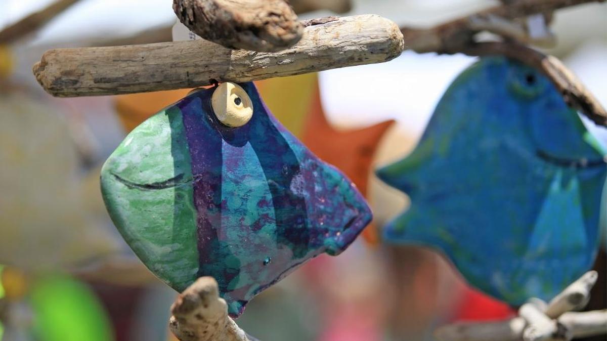 Whimisical fish created by pottery artist Dave Siegele dangle in the breeze at Art in the Park at Dinosaur Caves. The arts-and-crafts fair returns to Dinosaur Caves Park in Pismo Beach on Sunday.