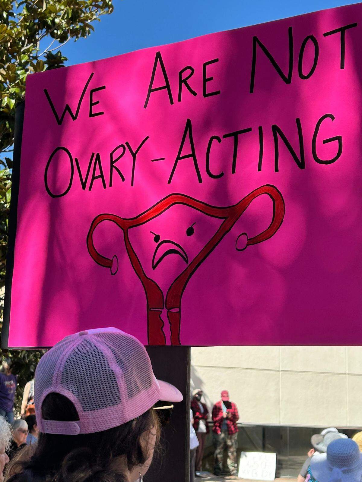 A woman holds up a sign Saturday while attending a protest and rally recognizing International Women’s Day, outside the courthouse in San Luis Obispo on March 8, 2025.