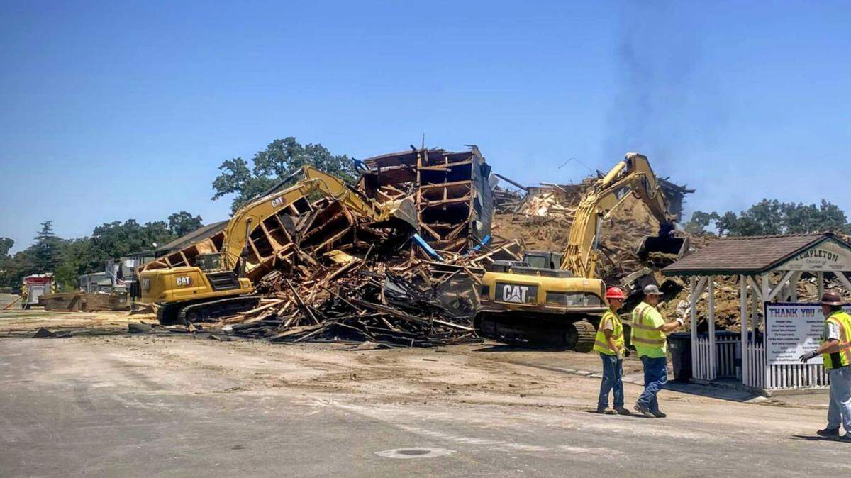 The northern tower of the burned-out Templeton Feed & Grain building was brought down on July 8, 2025, leaving a pile of rubble where the iconic granary stood for decades on South Main Street.