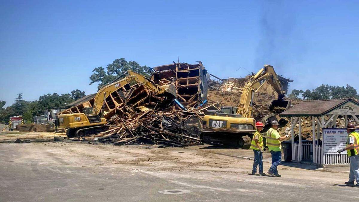 Remaining Templeton Feed & Grain tower crumbles to the ground