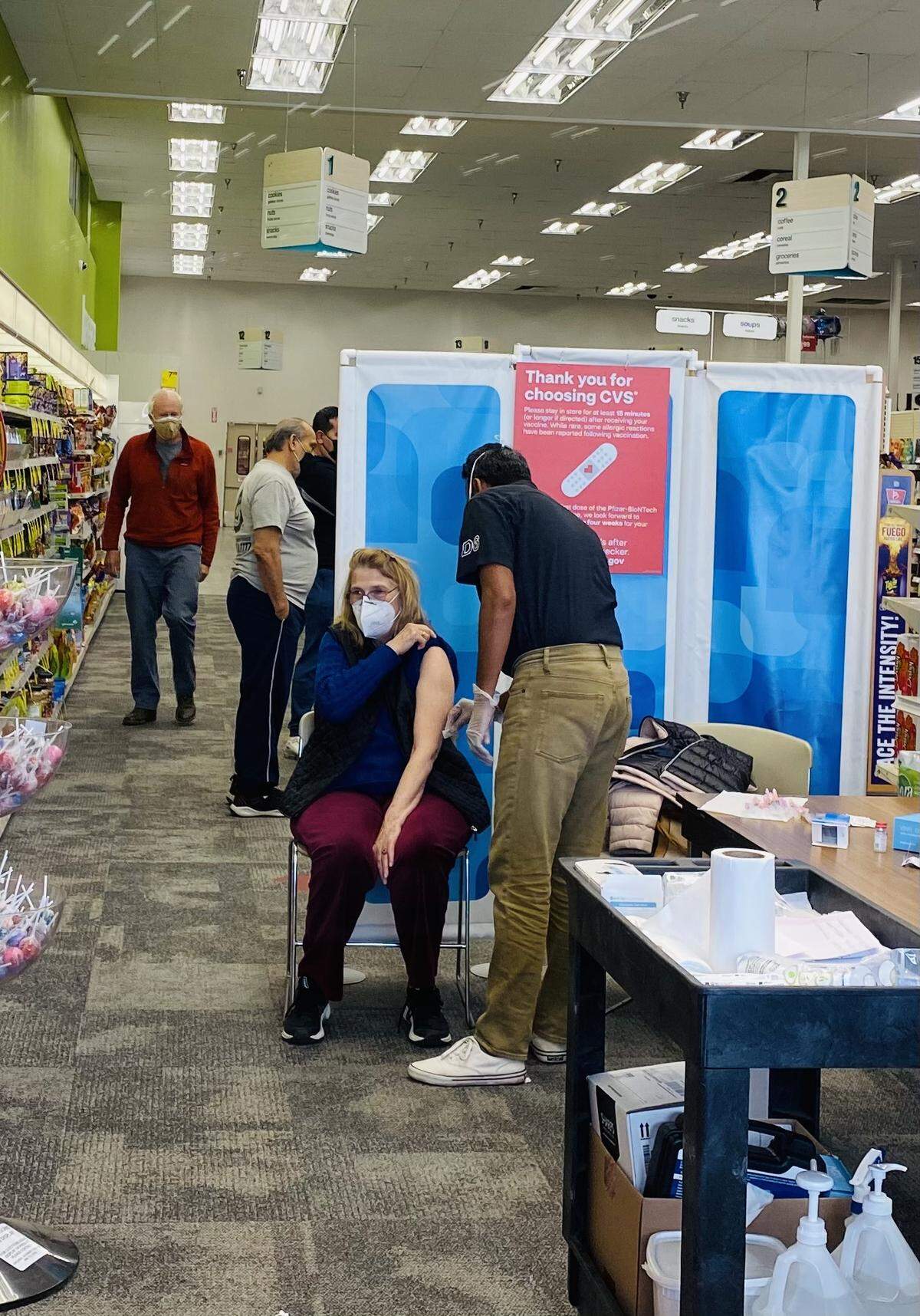 Paso Robles resident Margaret Rowson rolls up her sleeve to receive her coronavirus vaccine at a Bakersfield CVS. Rowson traveled to the Central Valley to get her shot after struggling to find a dose in San Luis Obispo County.