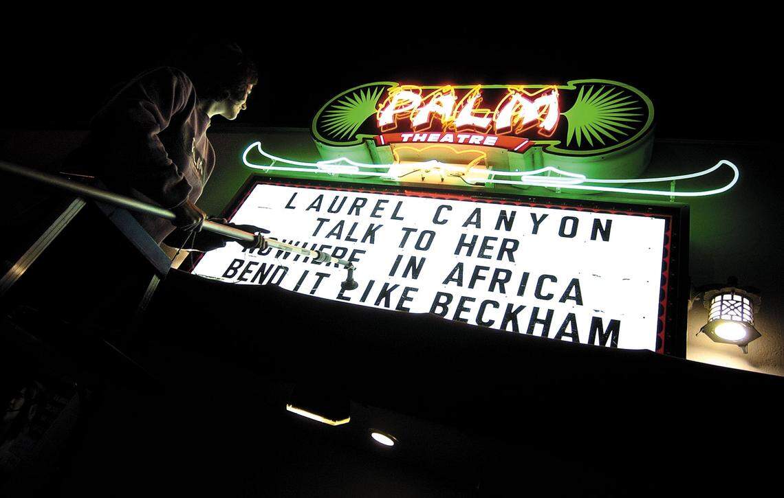 Catherine McDonald changes the marquee on the front of the Palm Theatre in 2003. 