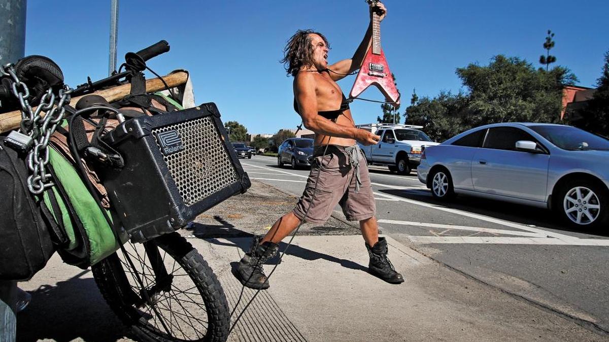 Tribune photographer Joe Johnston won second place in the best feature photo category for this photo of Bryan Thompson sending some heavy metal guitar licks through his bike mounted amplifier, left, during rush hour traffic at the intersection of Tank Farm Road and South Higuera in April 2015. "I'm trying to get signed," Thompson said.