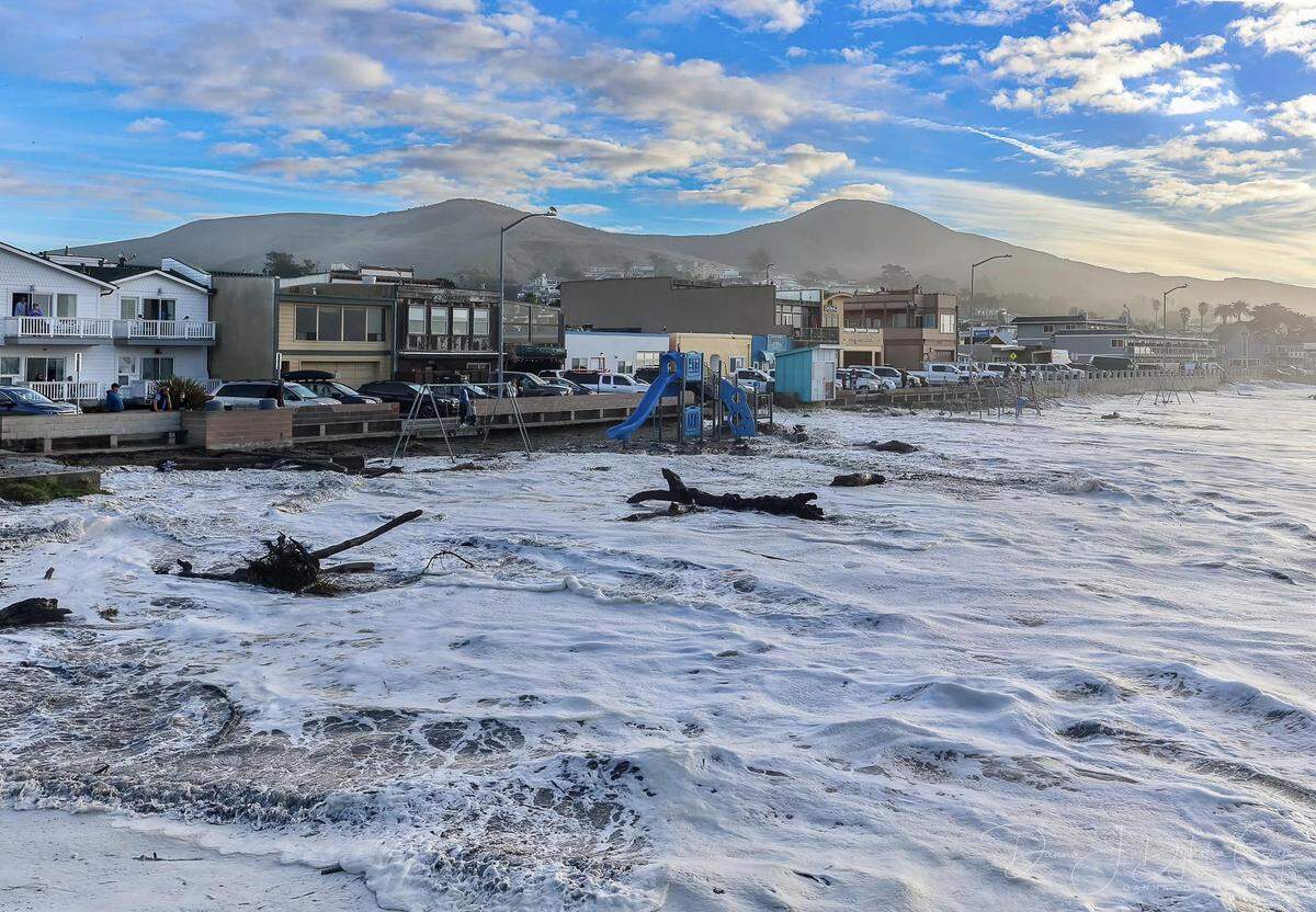 High surf sent waves all the way up the beach in Cayucos, flooding the playground and nearby streets on Thursday, Dec. 28, 2023.