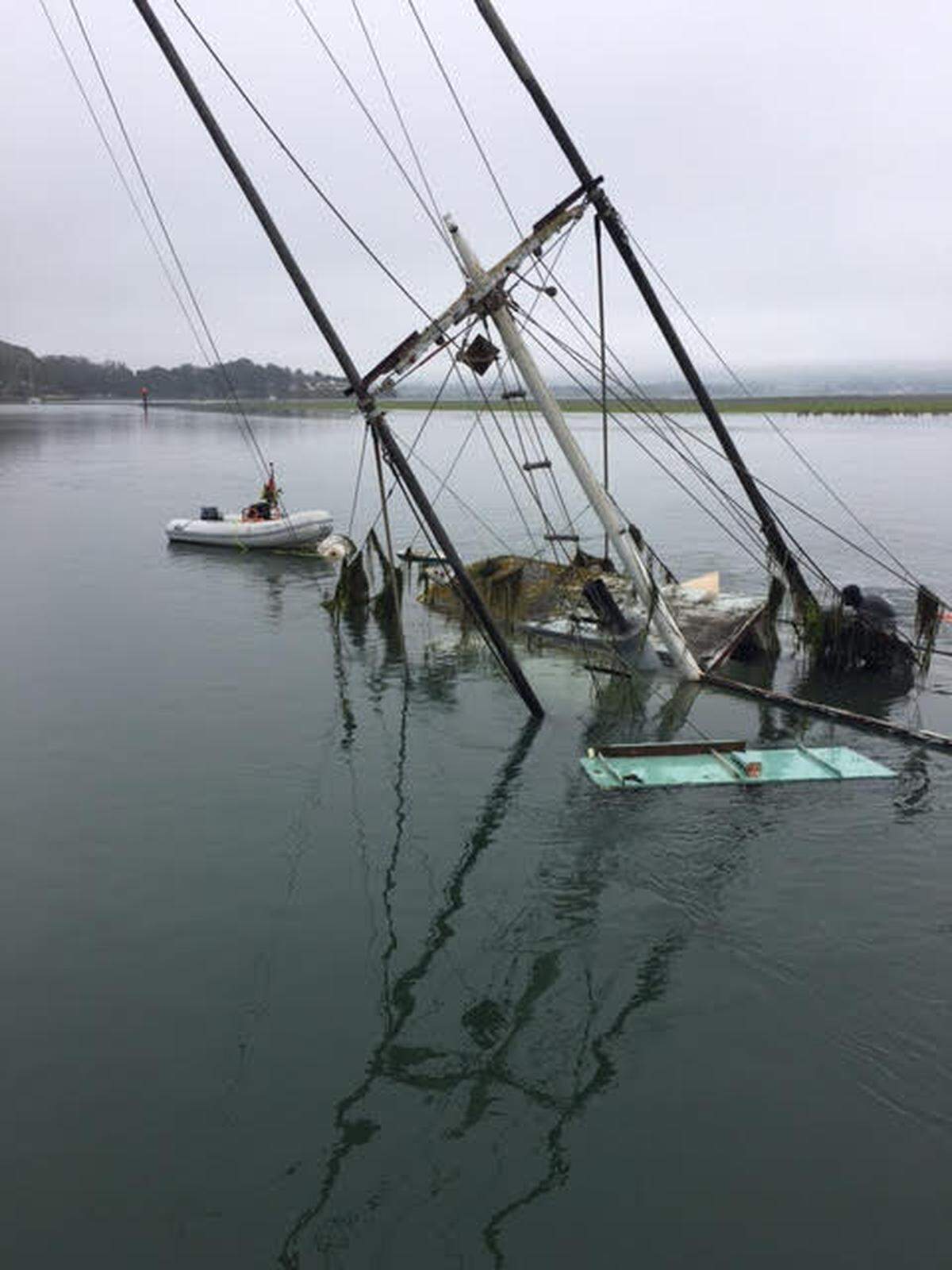 The fishing boat Lady Maxine is seen partially submerged in the Morro Bay Harbor.