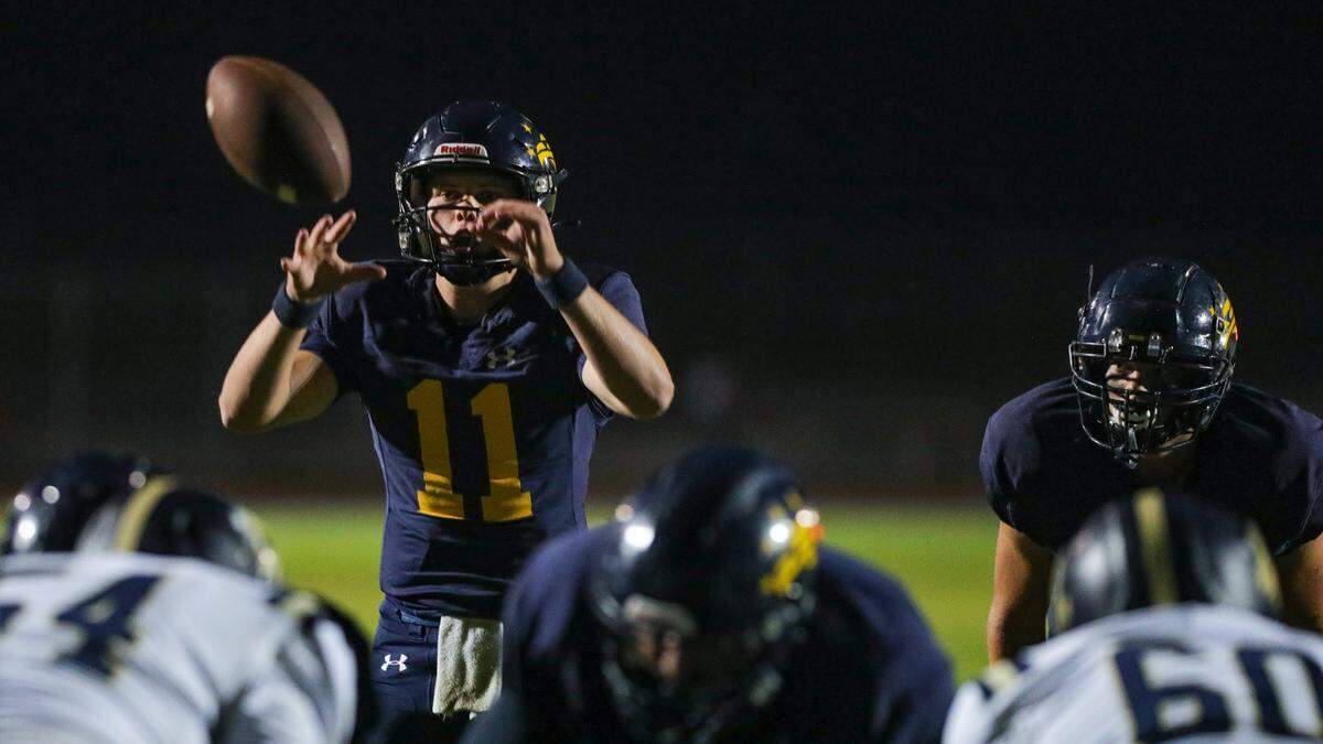 Sam Wulff takes a snap. Arroyo Grande High School beat Mission Prep 10-3 in a football game Oct. 13, 2023.