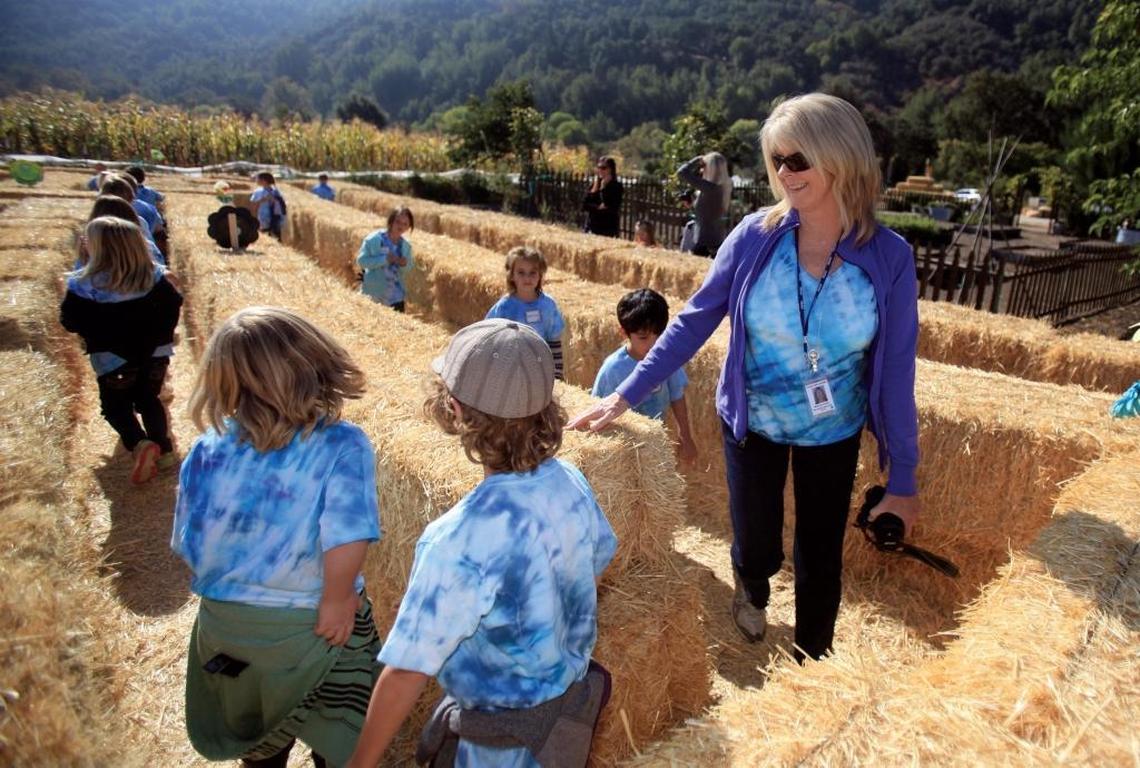 First grade teacher Carol Simpson joins her charges in the hay maze at Jack Creek Farms in Templeton.