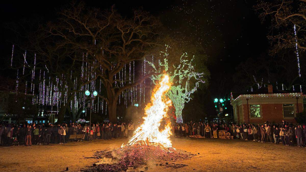 Revelers circle around the giant bonfire during Paso Robles’ New Year’s Eve celebration at the Downtown City Park on Dec. 31, 2023.
