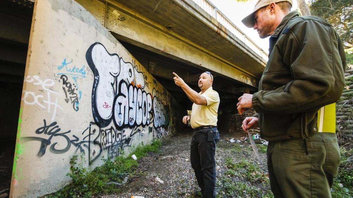 City biologist Freddy Otte, left, and Ranger Service supervisor Doug Carscaden describe how high the waters can climb during heavy winter storms in this area of San Luis Obispo Creek frequented by homeless people near the Marsh Street off-ramp.