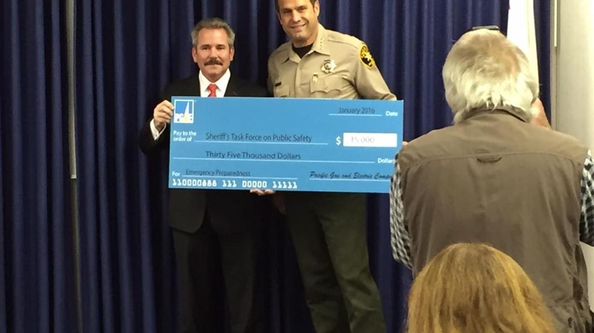 Sheriff Ian Parkinson is presented with a $35,000 check from Ed Halpin, PG&E’s senior vice president of generation and chief nuclear officer, for the Sheriff’s Public Safety Task Force.