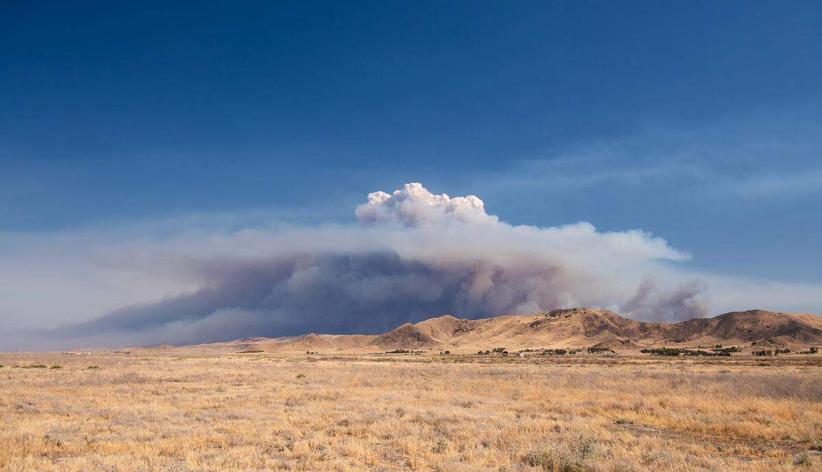 Flames from the Madre Fire send a towering plume of smoke into the sky in eastern San Luis Obispo County on July 2, 2025.