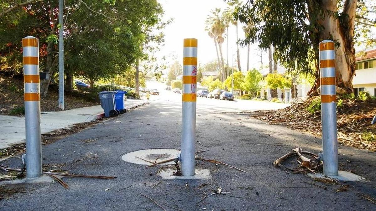 Bollards on Luneta Street stop cars from driving thru. A proposal by the city to open up the street to thru traffic has met with neighborhood opposition.
