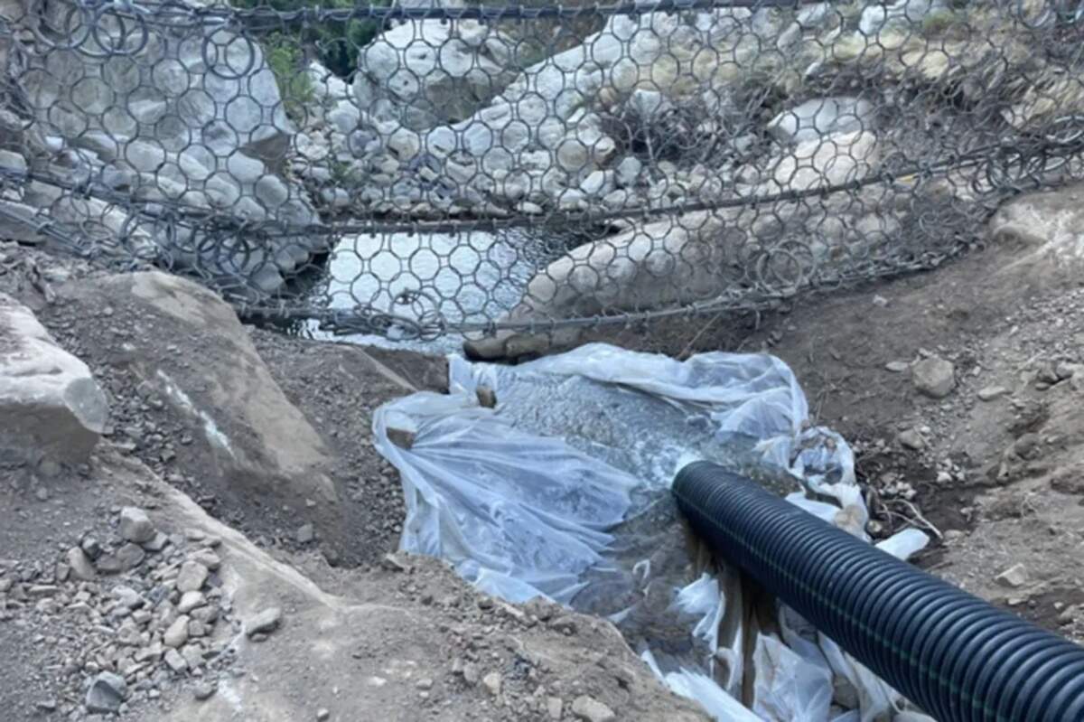 Piping was used to keep water flowing in San Ysidro Creek during clean-out of the debris net.