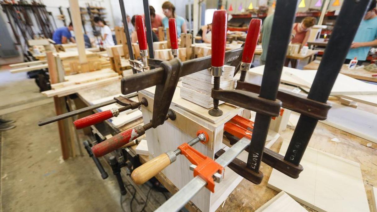 Cal Poly’s annual Vellum Furniture Design Exhibition features furniture that architecture students designed and built. Here, wood pieces are clamped while glue dries.