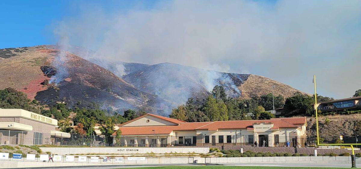 A fire burns the hillside behind off Lizzie Street behind San Luis Obispo High School on Monday, Oct. 30, 2023.