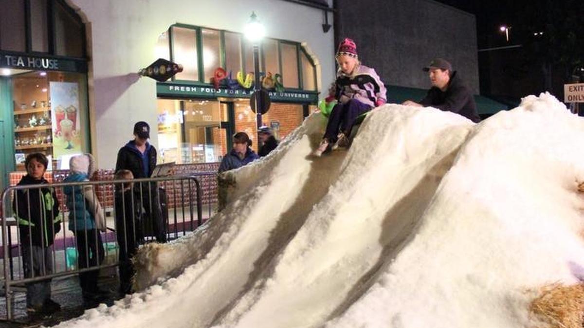 A child prepares for a sled ride at a past Snow Night event during the Thursday night downtown Farmers Market in San Luis Obispo.