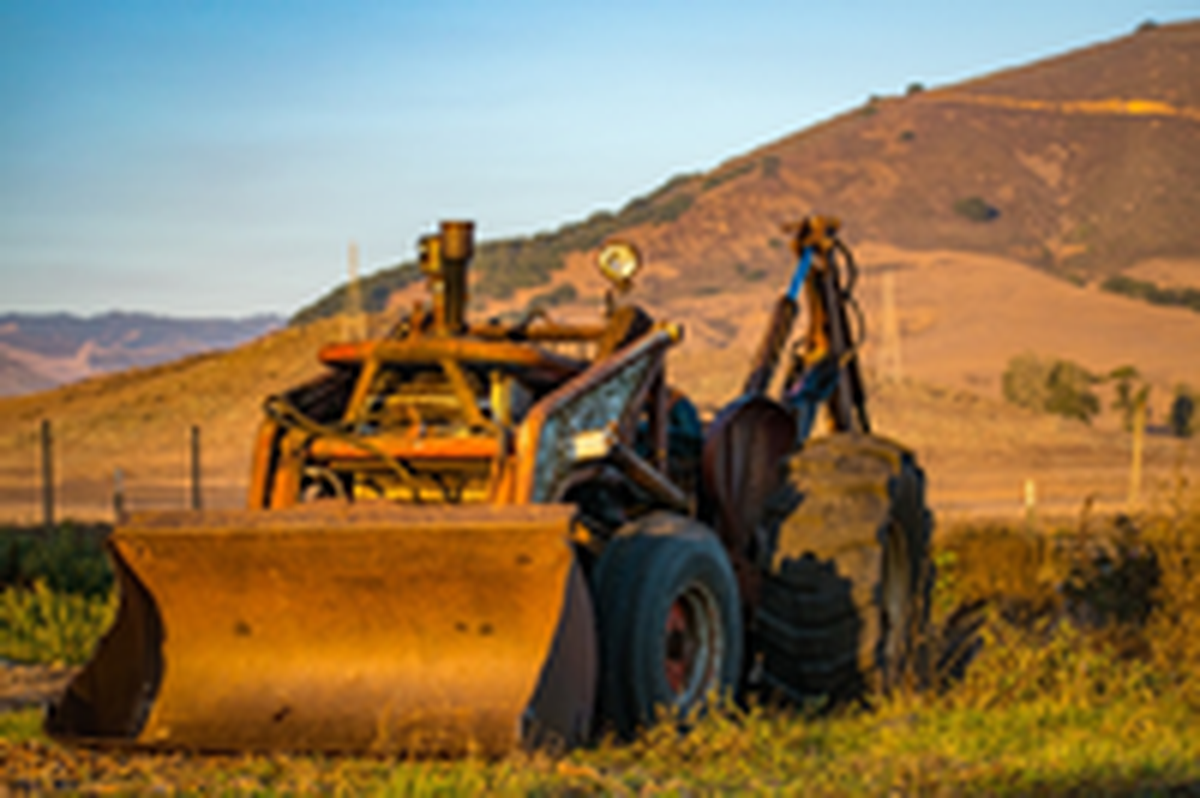 A tractor on the Sunny Acres site on Los Osos Road in San Luis Obispo. Four people have filed a lawsuit against ranch owner Dan DeVaul alleging labor violations.