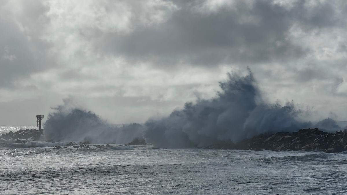 Powerful waves crash over the breakwater in Morro Bay on Saturday, Dec. 30, 2023.