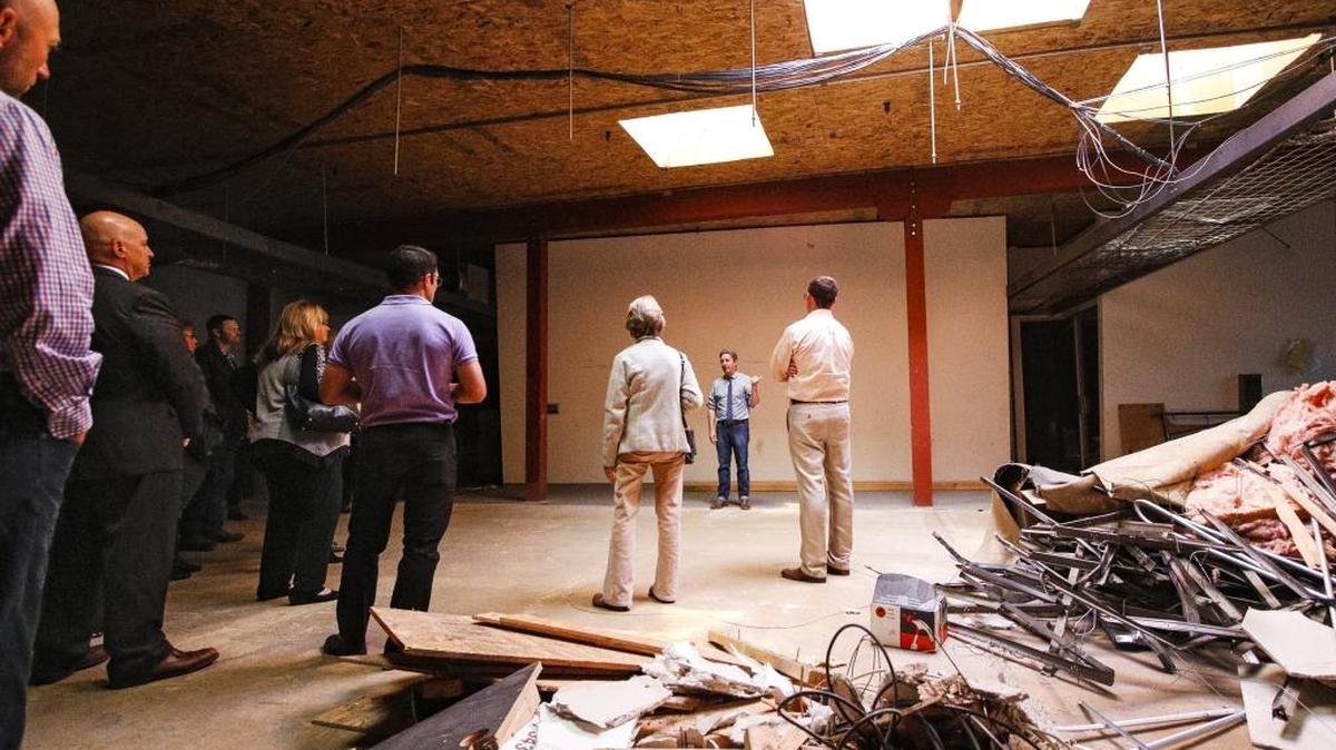 Cal Poly’s Center for Innovation and Entrepreneurship Executive Director Tod Nelson, center, gives members of the community a tour of the new HotHouse space above Ross Dress for Less on Nov. 12. The space, part of which is still under construction, will give students and community members seeking to grow start-up companies space and guidance to develop their businesses.
